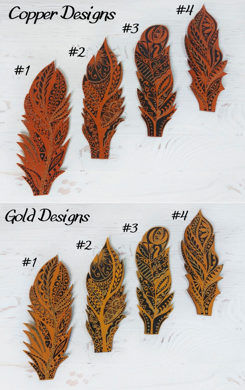 May include: Four copper and four gold feather-shaped bookmarks with black ink designs. The bookmarks are numbered 1 through 4 in both copper and gold.