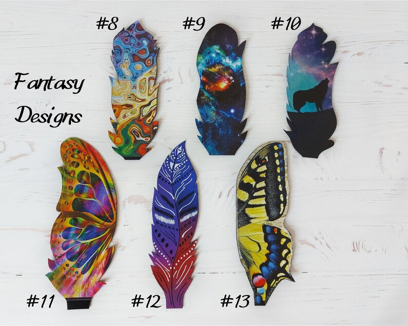 May include: A selection of fantasy-themed feather designs. The feathers display diverse patterns, including a galaxy, a wolf silhouette, and butterfly wings. The text "Fantasy Designs" is also visible.
