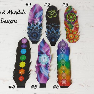 May include: Six decorative feather-shaped designs with yoga and mandala themes. The designs feature bright colours and detailed patterns, including the Om symbol, chakra symbols, and floral motifs. The text "Yoga & Mandala Designs" is also present.