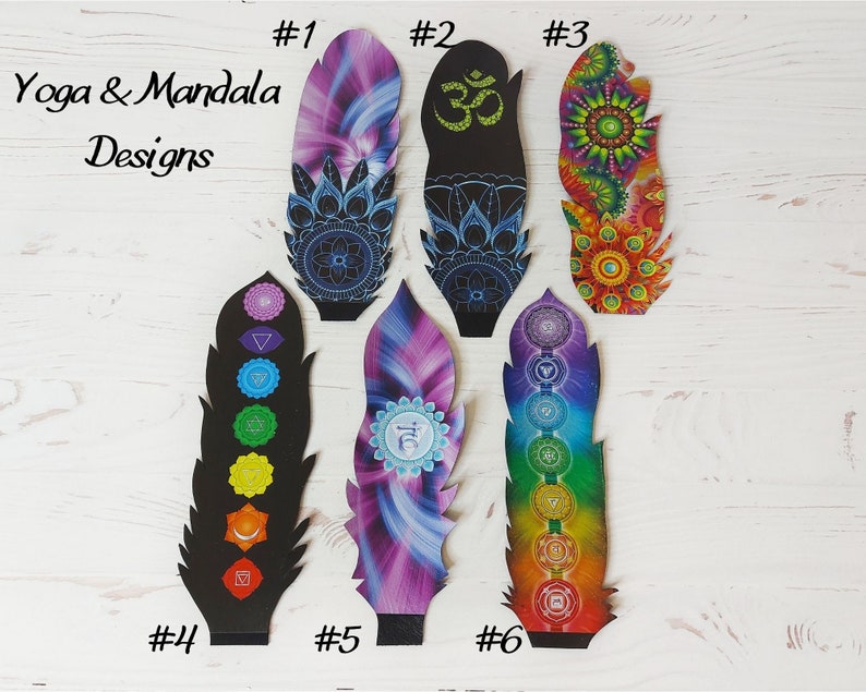 May include: Six decorative feather-shaped designs with yoga and mandala themes. The designs feature bright colours and detailed patterns, including the Om symbol, chakra symbols, and floral motifs. The text "Yoga & Mandala Designs" is also present.