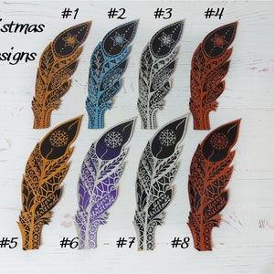 May include: A collection of eight decorative feather ornaments with intricate designs and the words "Merry Christmas." The feathers are in various colors, including gold, blue, silver, and orange. The text "Christmas Designs" is also visible.