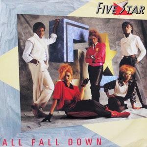May include: Five Star, a music group, pose for a photo shoot. The group are standing in front of a large, blue and white letter "F" and a gold star. The album cover features the title "All Fall Down".