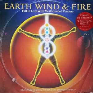 May include: Album cover for Earth, Wind & Fire's "Fall In Love With Me (Extended Version)". The artwork features a stylized human figure with glowing energy centers, set against a backdrop of a planet and a dark blue sky. Includes a sticker that says "Contains the bonus track SOMETHING SPECIAL".
