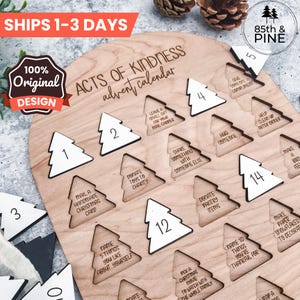 May include: Wooden Acts of Kindness advent calendar with numbered tree-shaped cutouts. The calendar includes various acts of kindness suggestions. The text "ACTS OF KINDNESS advent calendar" is visible. The design is original.