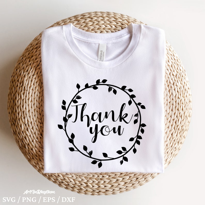May include: White t-shirt with a black wreath design and the text "Thank you" in a cursive font.