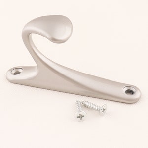 May include: A silver-toned metal hook with a curved design. The hook comes with two screws for installation.