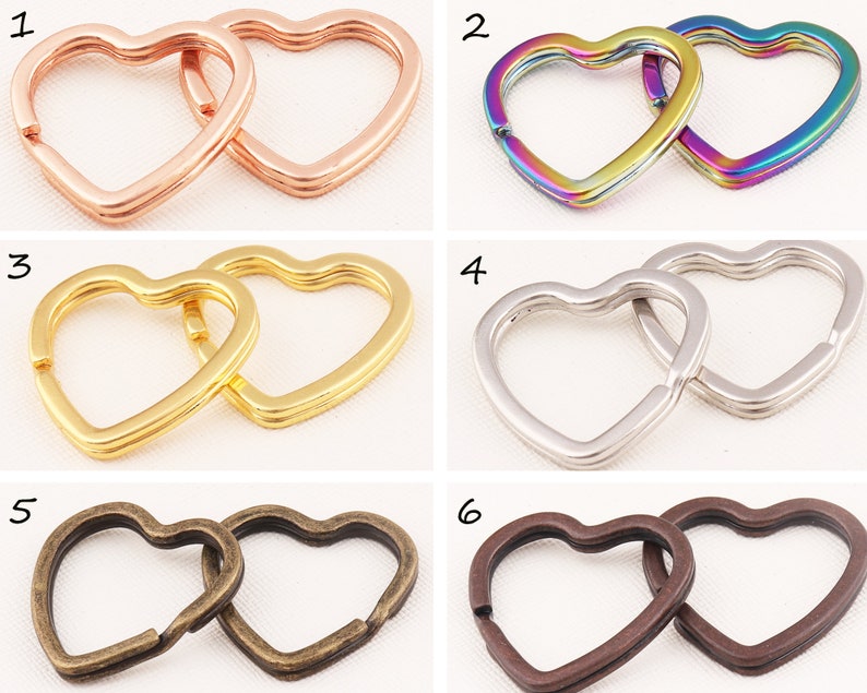 K&ouml;nnte beinhalten: Sechs Paare herzf&ouml;rmiger Schl&uuml;sselringe in verschiedenen Ausf&uuml;hrungen: Ros&eacute;gold, Regenbogen, Gold, Silber, Antikmessing und Braun.