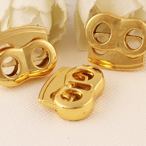 Bloqueo del cordón de resorte, bloqueo de cable ovalado de oro doble barril doble agujeros de cordón de bloqueo, bloqueo de palanca de tapón extremos-15mmx4mm * 12-24pcs