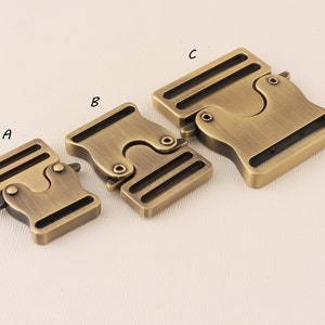 May include: Three antique gold metal buckle closures, labelled A, B, and C, for straps or belts.