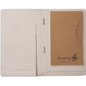 May include: Open, off-white leather portfolio with pockets and a notepad. The notepad is brown with the word "Wanderings" and a compass rose graphic. The portfolio has a stitched border.