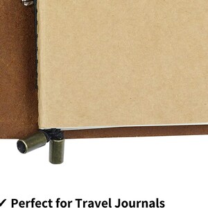 May include: A brown leather bound journal with a blank, cream-colored paper insert. The journal has a black string closure with two metal toggles.