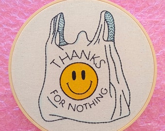 May include: Embroidered plastic bag with a smiley face and the text "Thanks for nothing".