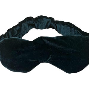 May include: A dark green velvet sleep mask with an elastic band.
