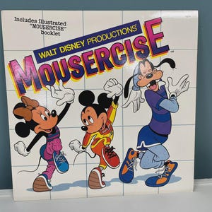 May include: A vintage record album cover featuring Mickey Mouse, Minnie Mouse, and Goofy exercising. The album is titled "Walt Disney Productions' Mousercise" and includes an illustrated booklet.