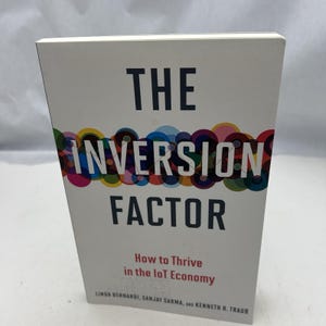 May include: A book titled "THE INVERSION FACTOR" with a colourful design on the cover. The subtitle is "How to Thrive in the IoT Economy." The authors' names are printed at the bottom of the book.