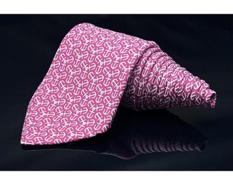May include: A pink silk tie with a white anchor pattern.