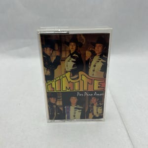 May include: A Grupo Límite music cassette tape. The cassette case features a photo of the band members in black and white outfits. The band's name, "Límite", is in large yellow letters, with the album title "Por Puro Amor" below.