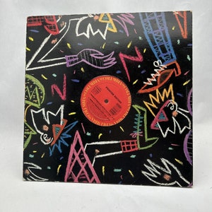 May include: A vintage vinyl record album by the Pointer Sisters. The album cover is black with colourful abstract designs in white, pink, yellow, green, and blue. The record label is red with white text.