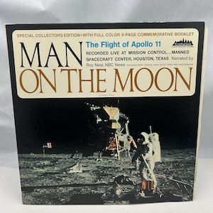 May include: A vintage vinyl record cover featuring a black and white photo of the Apollo 11 lunar module on the moon. The cover is titled "Man on the Moon: The Flight of Apollo 11" and features the text "Recorded live at Mission Control... Manned Spacecraft Center, Houston, Texas. Narrated by Roy Neal, NBC News."