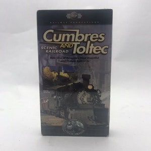 May include: A VHS tape for "Cumbres and Toltec Scenic Railroad" by Railway Productions. The cover features a steam train and the text "Ride One of America's Most Beautiful and Historic Railroads". The bottom has a logo for "America's Steam Trains".