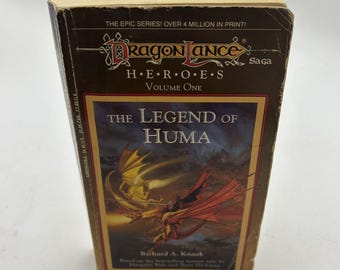 May include: A well-worn copy of "Dragonlance: Heroes, Volume One: The Legend of Huma" by Richard A. Knaak. The cover features a fantasy illustration of dragons in flight. The book's title and author are prominently displayed.