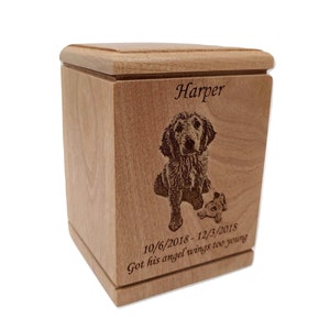 May include: A wooden pet urn with a laser engraved image of a dog and the text "Harper 10/6/2018-12/3/2018 Got his angel wings too young".