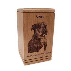 May include: A wooden pet urn with a laser engraved image of a bulldog and the name "Troy" with the dates "March 27, 2007 - April 13, 2020".