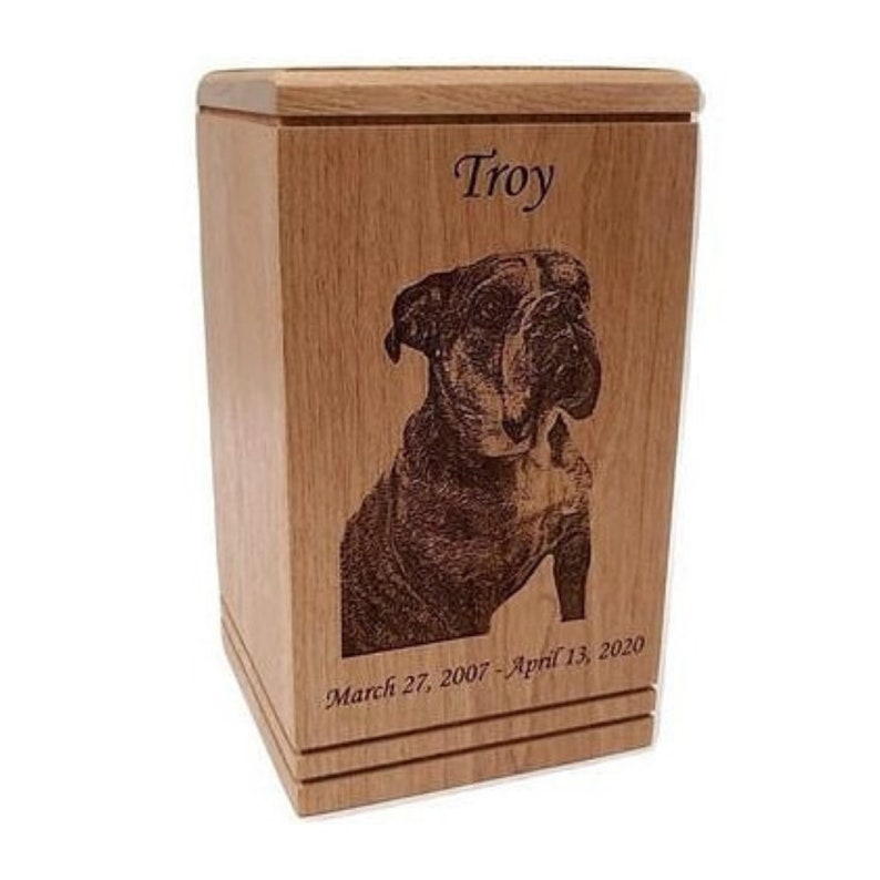May include: A wooden pet urn with a laser engraved image of a bulldog and the name "Troy" along with the dates "March 27, 2007 - April 13, 2020".