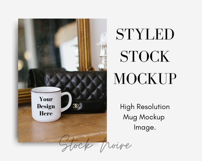 May include: White ceramic mug with a black rim and handle. The mug has the text "Your Design Here" printed on it. The mug is sitting on a wooden surface next to a black quilted handbag.