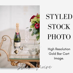 Gold Bar Cart Styled Stock Photo,  His and hers glasses, Champagne bottle on gold bar cart stock photo