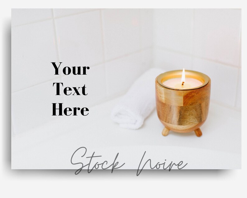 May include: A wooden candle holder with a gold rim and three legs, holding a lit candle. A white towel is on the surface next to the candle holder. The background is a white tiled wall. "Your Text Here" is written in black text on the left side of the image. "Stock Noire" is written in gray cursive text at the bottom of the image.