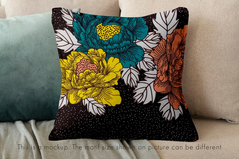 May include: A black and white floral pillow with teal, yellow, and orange flowers. The pillow has a white background with black polka dots.