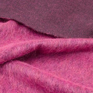 Soft fabric blend with wool, alpaca, and mohair, featuring a bold pink color.