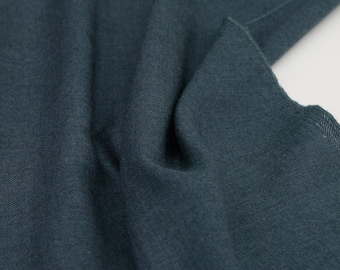 May include: Close-up of a dark blue fabric with a smooth, textured surface.