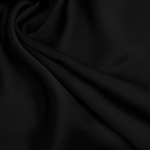 May include: Black fabric with a smooth, silky texture. The fabric is draped and folded, creating soft curves and folds.