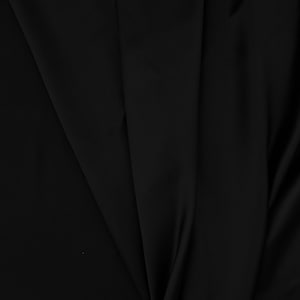 May include: Black fabric with a smooth, silky texture. The fabric is folded and draped, creating soft folds and curves.