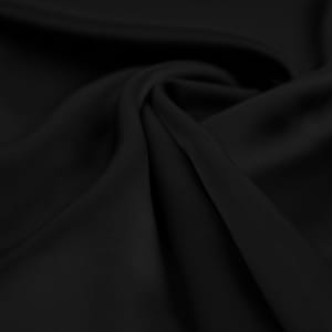 May include: Black fabric with a smooth, silky texture. The fabric is draped and folded, creating soft curves and folds.