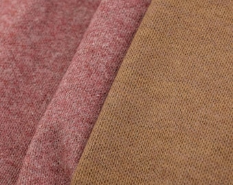 May include: Close-up of three different fabric swatches. The first is a reddish-pink, the second is a darker pink, and the third is a tan color. All three fabrics have a textured, knitted appearance.