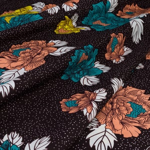 May include: Black fabric with a white, teal, and peach floral pattern. The fabric has a subtle speckled texture.
