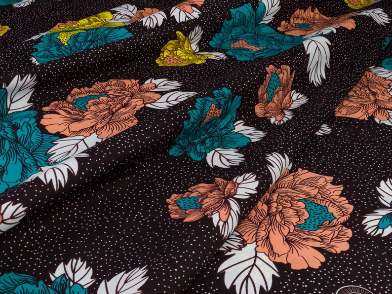 May include: Black fabric with a white, teal, and peach floral pattern. The fabric has a subtle speckled texture.