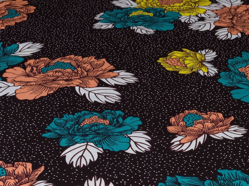 May include: Black fabric with a repeating pattern of teal, orange, and yellow flowers. The flowers have white outlines and are set against a black background with white dots.