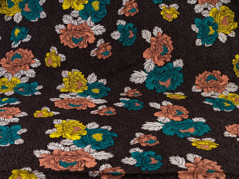 May include: Black fabric with a repeating pattern of pink, yellow, and teal flowers. The flowers have white outlines and are on a black background with white dots.