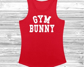 May include: Red tank top with white text that reads "GYM BUNNY".