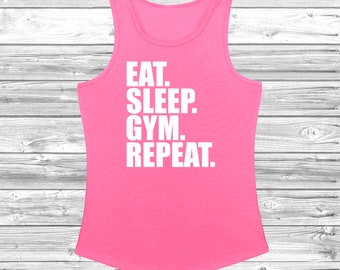 May include: Pink tank top with the text "Eat. Sleep. Gym. Repeat." in white.