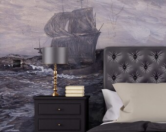 May include: A bedroom interior with a black headboard and a bedside table with a lamp. The wall behind the bed features a painting of a ship sailing on a stormy sea.