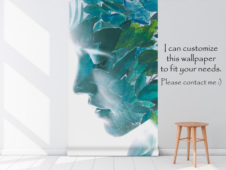 May include: A wallpaper roll featuring a serene face profile, overlaid with watercolor leaves in shades of blue and green. The text on the wallpaper reads, "I can customize this wallpaper to fit your needs. Please contact me :)". A small wooden stool sits nearby.