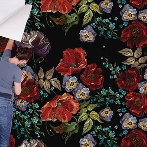 May include: A black background with a repeating pattern of embroidered red poppies, blue forget-me-nots, and purple pansies. The flowers are arranged in a random pattern and are surrounded by green leaves.
