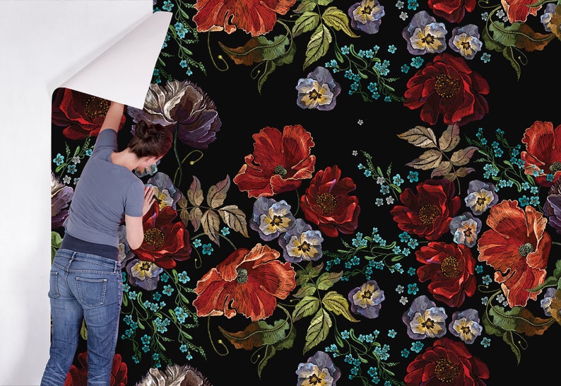 May include: A black background with a repeating pattern of embroidered red poppies, blue forget-me-nots, and purple pansies. The flowers are arranged in a random pattern and are surrounded by green leaves.