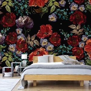 May include: A black background with a floral pattern of red, purple, and blue embroidered flowers. The flowers are arranged in a diagonal pattern and are surrounded by green leaves.