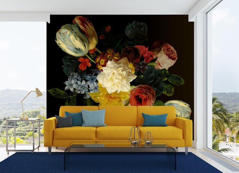 May include: A yellow couch with blue pillows in front of a wall mural featuring a large bouquet of colorful flowers, including tulips, roses, and lilies, on a black background.